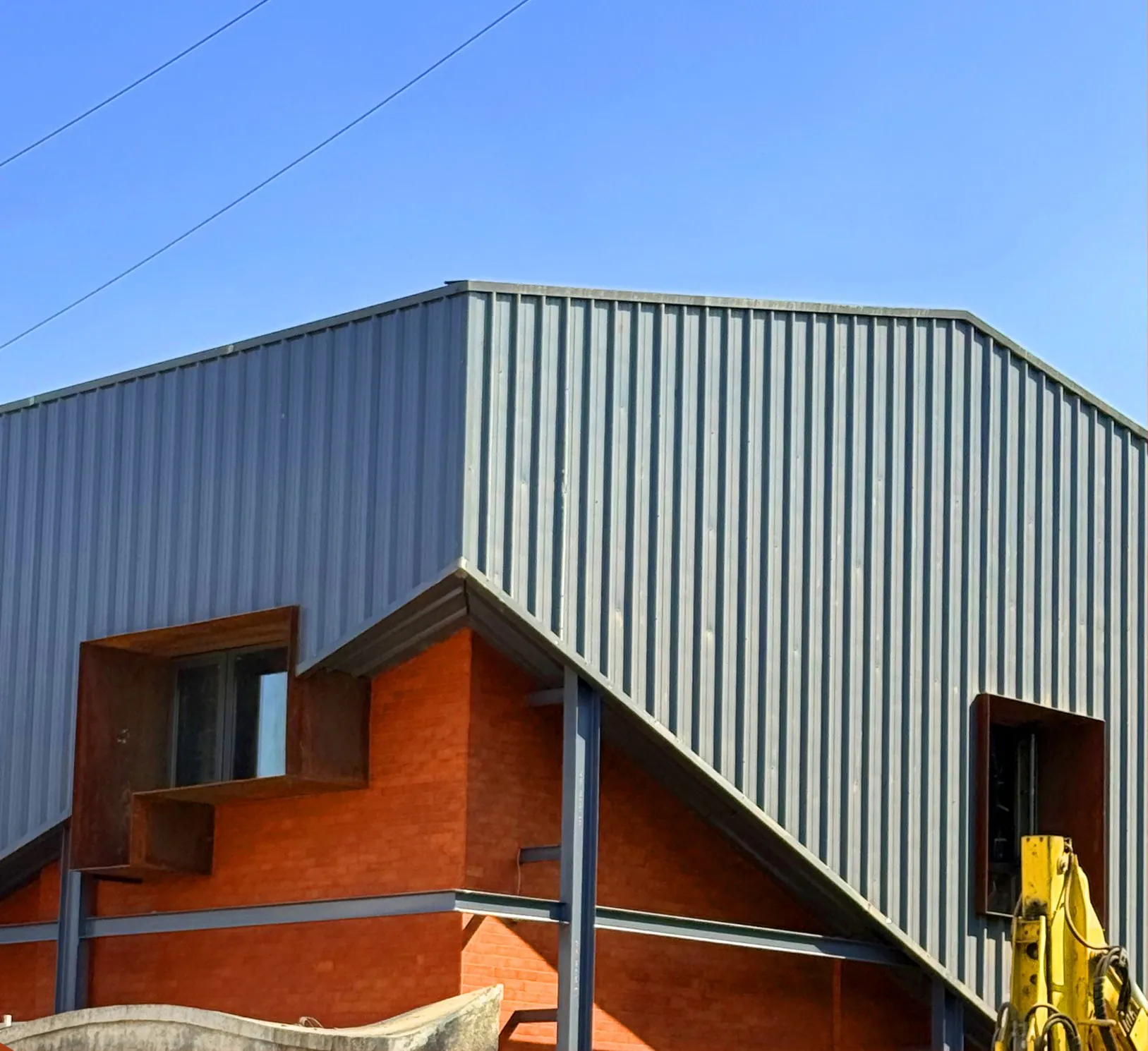 The Barn, Navi Mumbai, India: The corrugated shell and its Corten steel windows