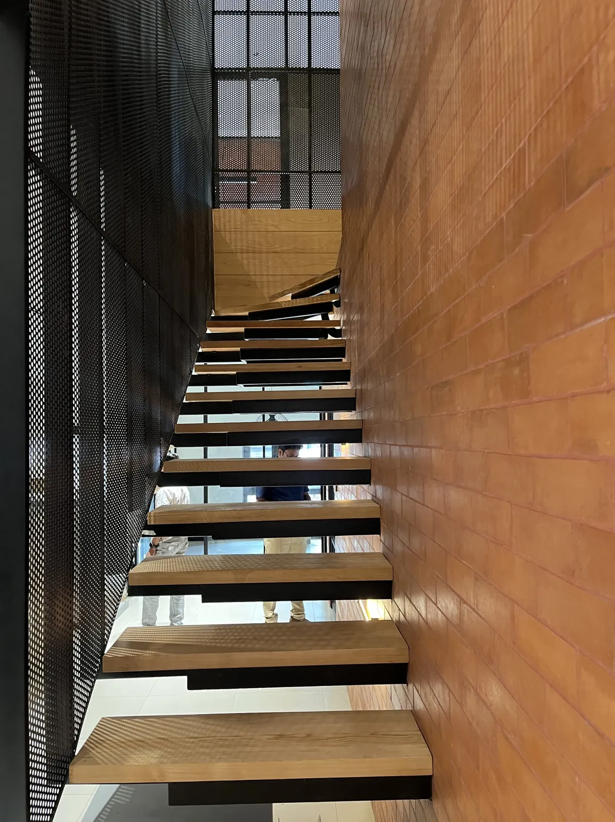 The Barn: The cantilevered oak stair against the brick wall