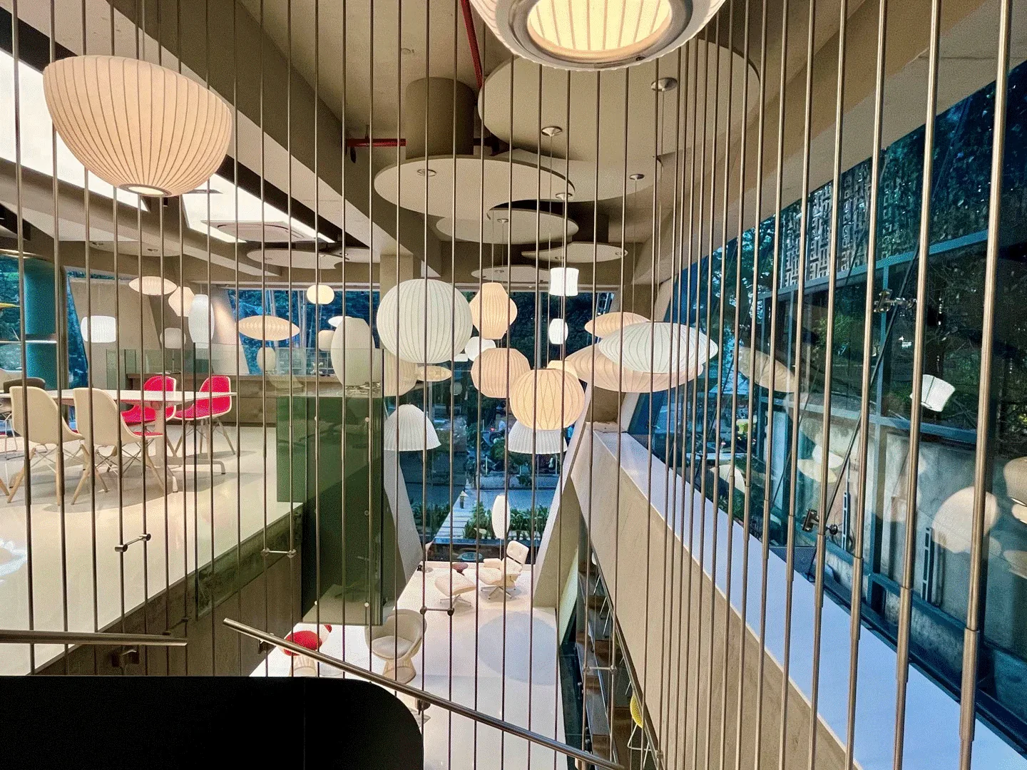 MillerKnoll Experience Center: Lamps seen through the wire balustrade